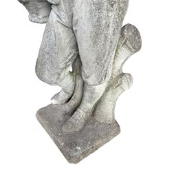 Haddonstone - weathered cast stone garden statue of a boy holding a basket of grapes, modelled with curled locks of hair wearing a tunic and breeches leaning against a naturalistic tree stump, on square base