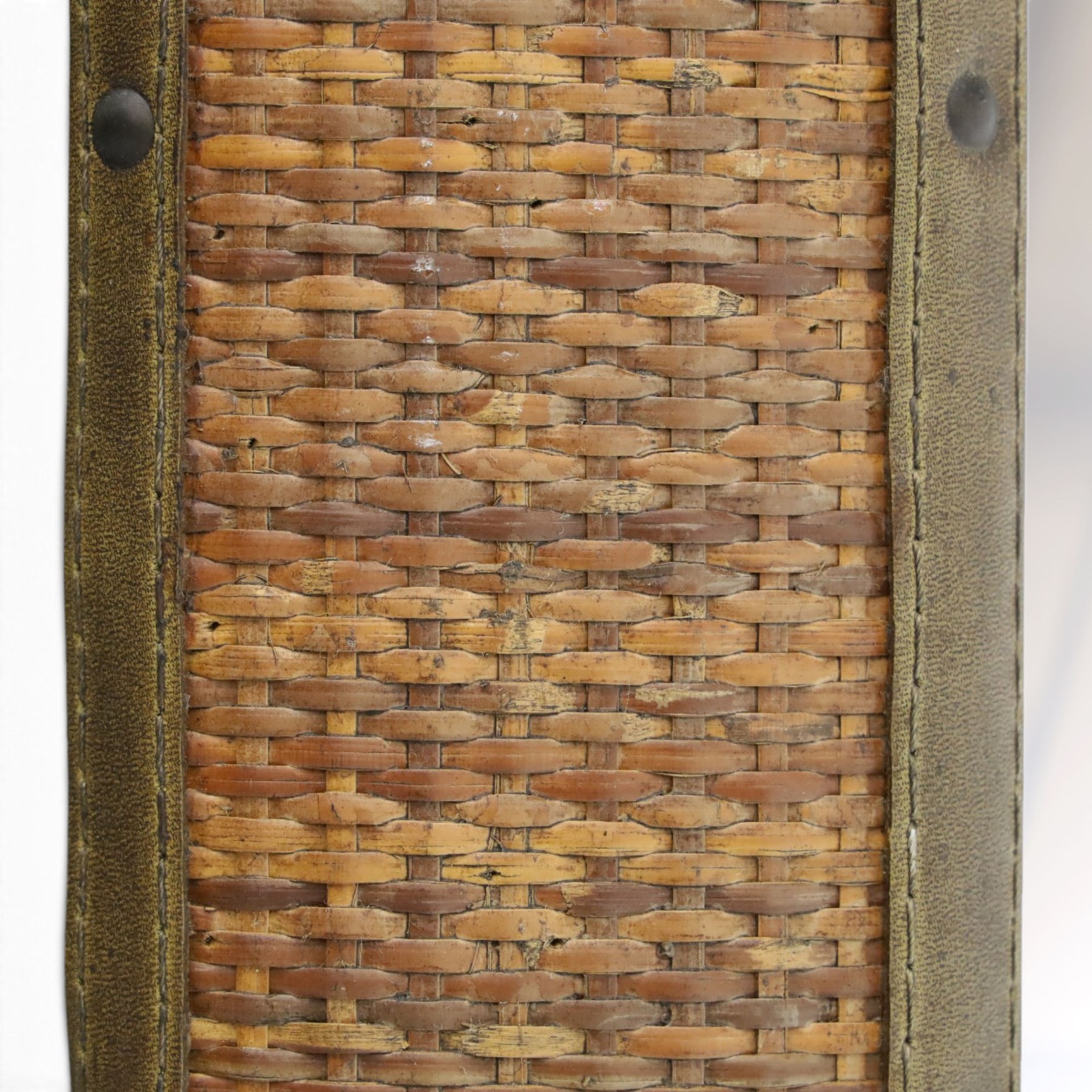 Rustic wall mirror with brass, leather and rattan frame, enclosing a bevelled plate