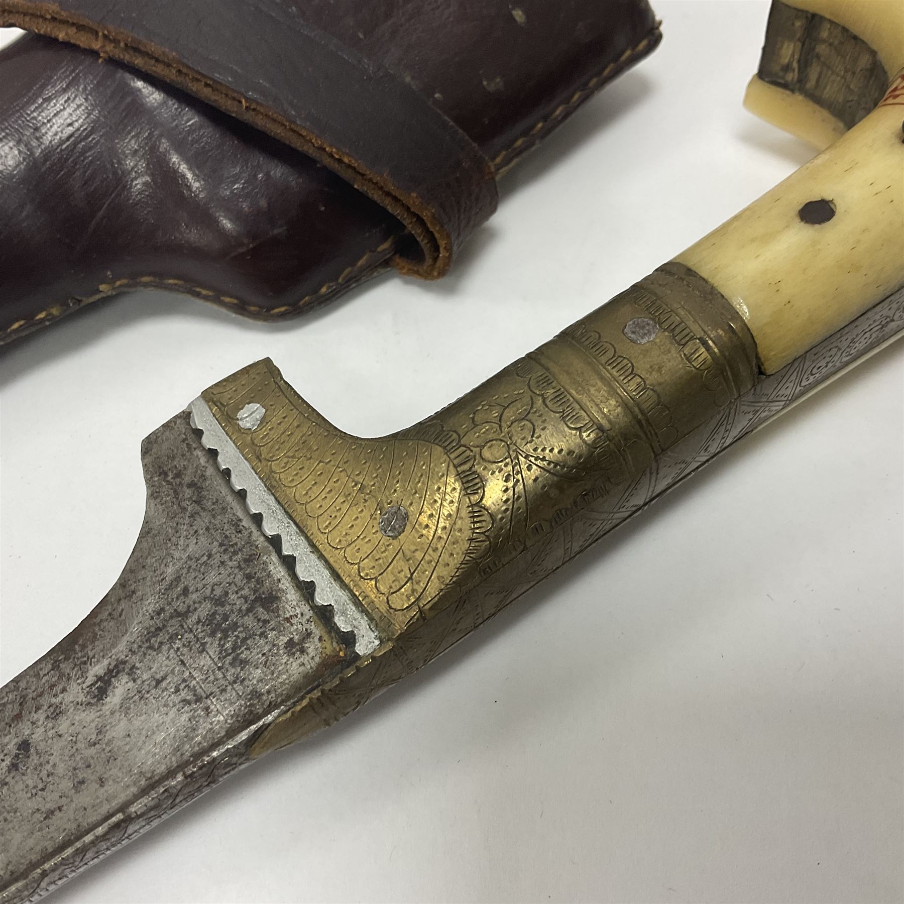 Afghan Khyber knife (Choora), blade engraved along the top edge with ornate brass and bone grip, with leather scabbard, overall L31cm, blade L20cm