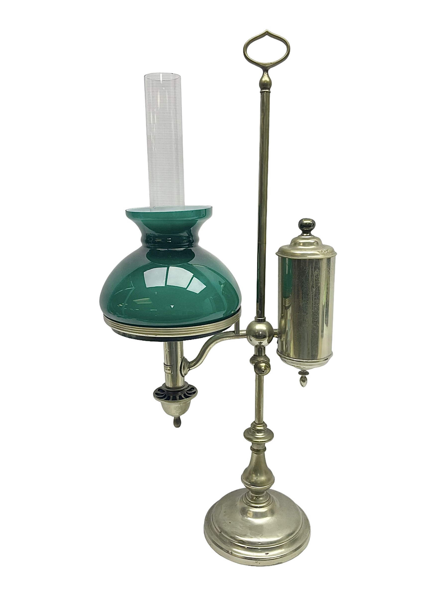 William H Honey polished brass adjustable student's oil lamp, with green glass shade, H60cm