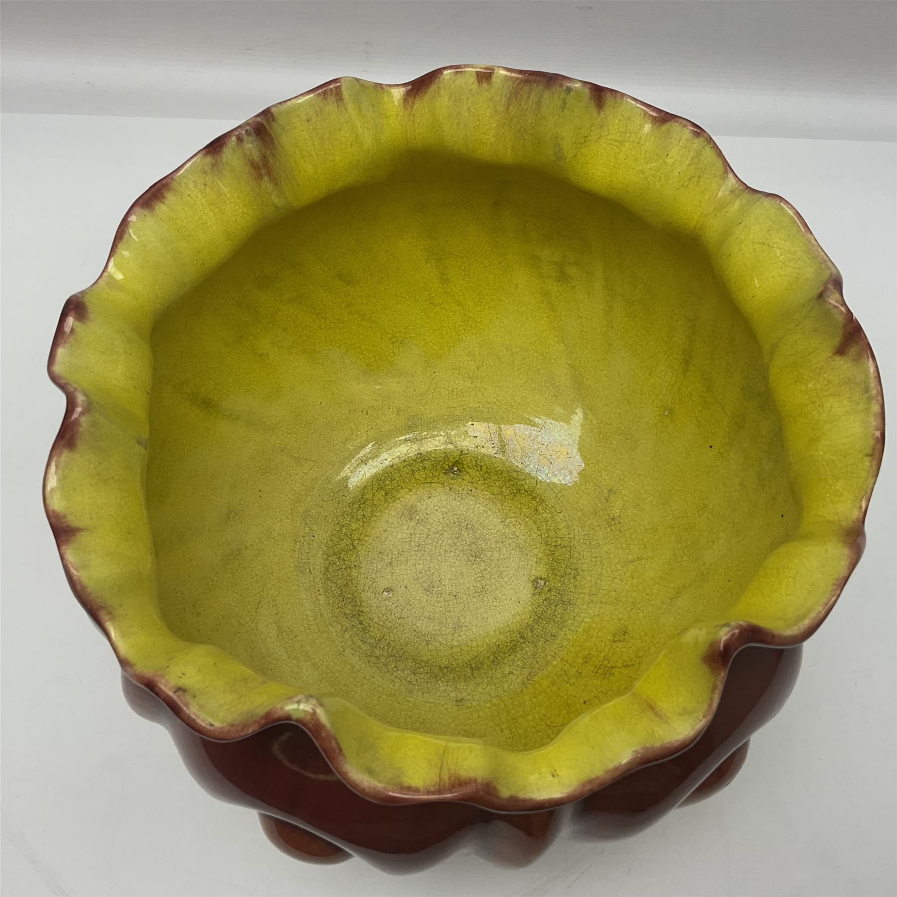 Bretby Jardiniere and stand, with foliate and foliage decoration with a red and yellow ground, impressed mark beneath H94cm