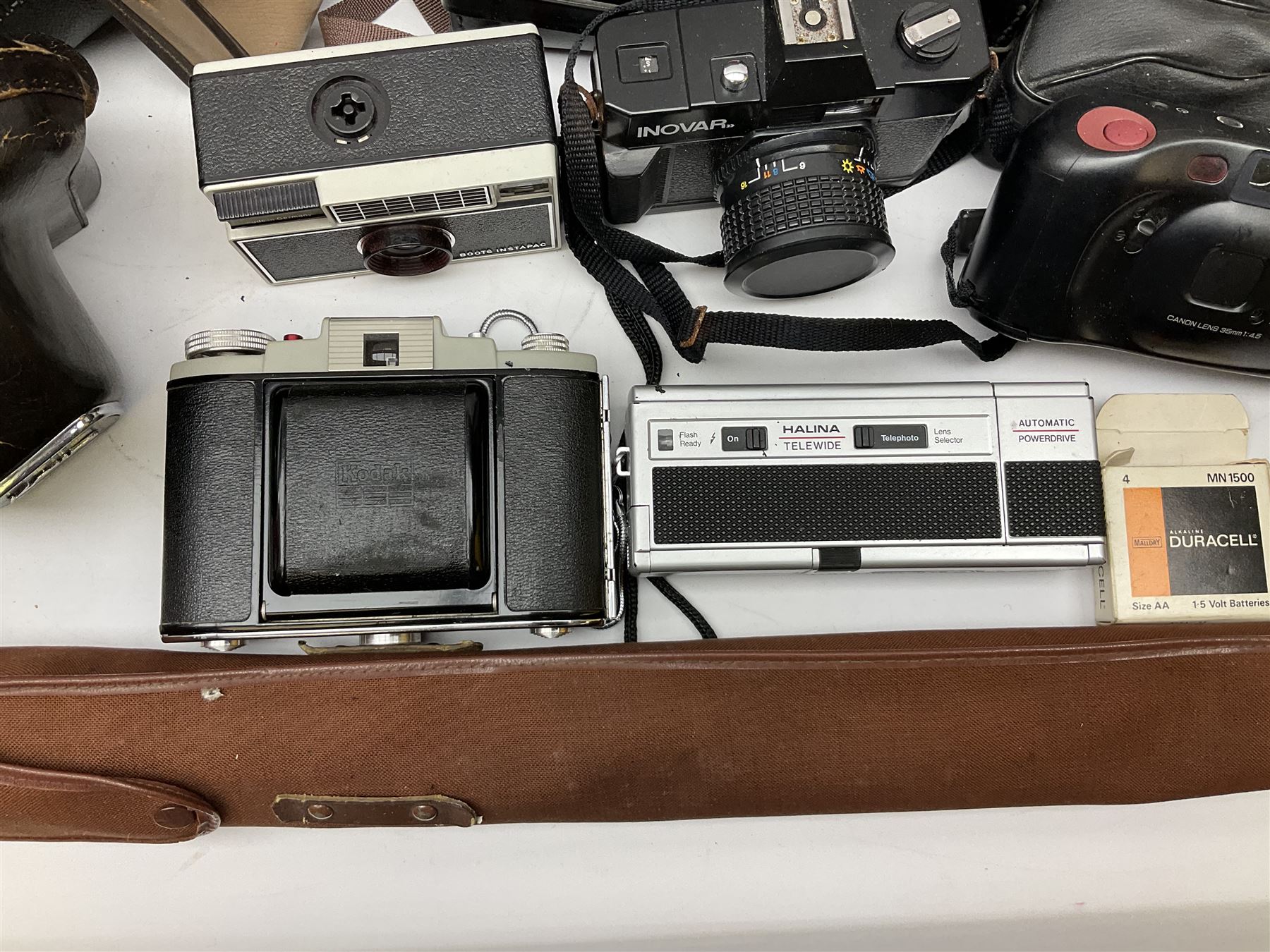 Quantity of Cameras , Lenses and Table Top Viewer- To be assessed 
Collection of cameras, lenses and photography equipment, to include Praktica EE2, Kowa SE, Kodak 66 model II, Inovar, lens Carl Zeiss Jena DDR Flektogon 2.4/35, lens Pentacon Electric f/2.8 135mm, Sunpak auto 2020, tripod  etc, together with a pair of Mark Scheffel 10x50 field binoculars.  