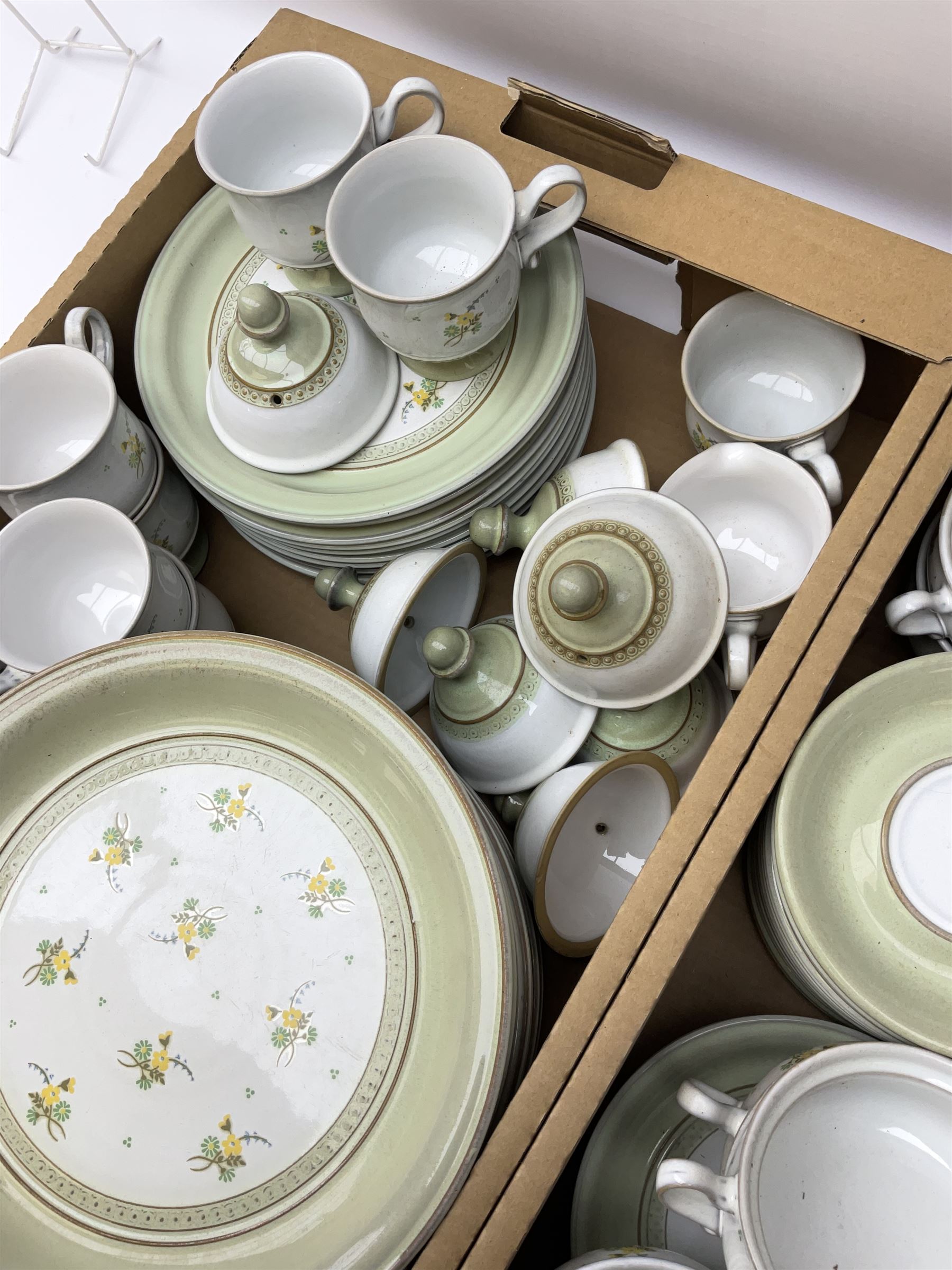 Quantity of Denby Verona pattern tea and dinner wares, decorated with floral sprays and within green borders, to include lidded twin handled bowls, teacups and saucers, dinner plates etc in two boxes