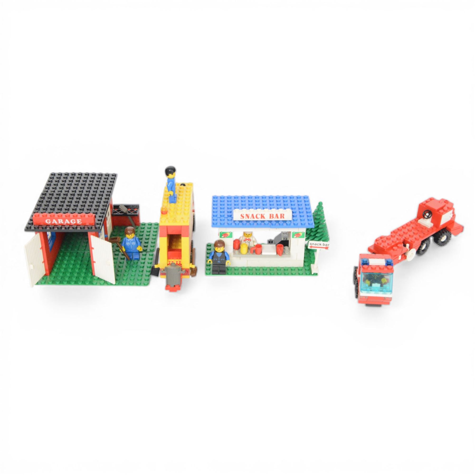 Nine vintage Lego Classic Town vehicles and buildings,  comprising no. 368-1 Taxi  Station, no. 675-1 Snack Bar, no. 374-2 Fire Engine, no. 643-2 Mobile Crane, no. 361-2 Garage, no. 00-2 Weetabix Promotional House, no. 6693 Recycle Truck, no. 6450-1 Mobile Police Truck and no. 6358 Snorkel Squad, all built with minifigures