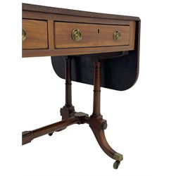 George III mahogany sofa table, rectangular drop-leaf top with reed moulded edge and rounded corners, fitted with two frieze drawers and two opposing false drawers, quadruple collar turned pillar supports on turned and block platforms, splayed and moulded supports with brass cups and castors 