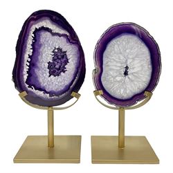 Pair of purple agate slices, polished with rough edges raised upon gilt metal stands