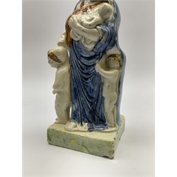 Late 18th century Prattware figure representing Charity, modelled as a mother with baby in her arms and two small children clutching at her robes, upon a square base, overall H21cm.