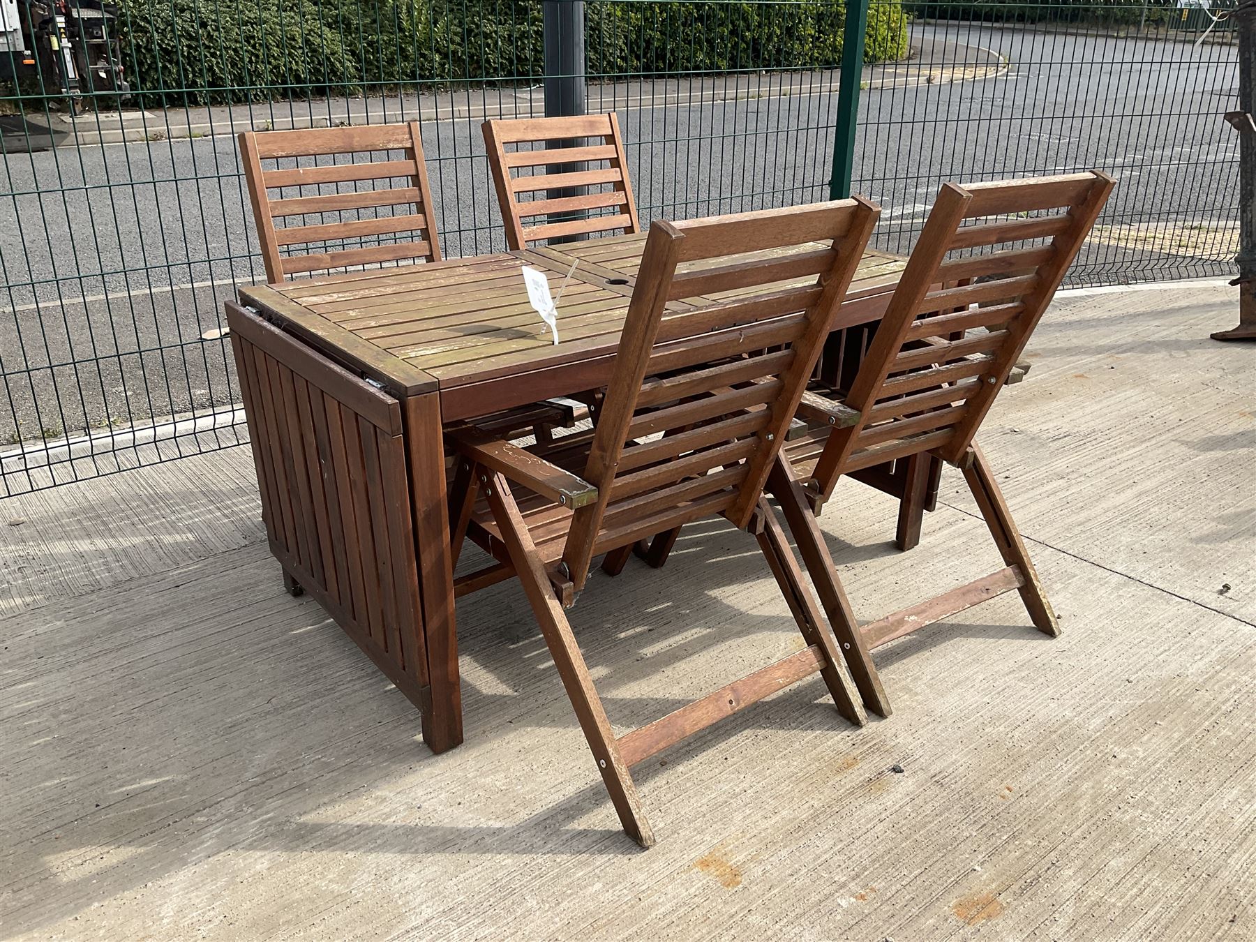 Rectangular teak drop leaf garden table, and four slatted armchairs