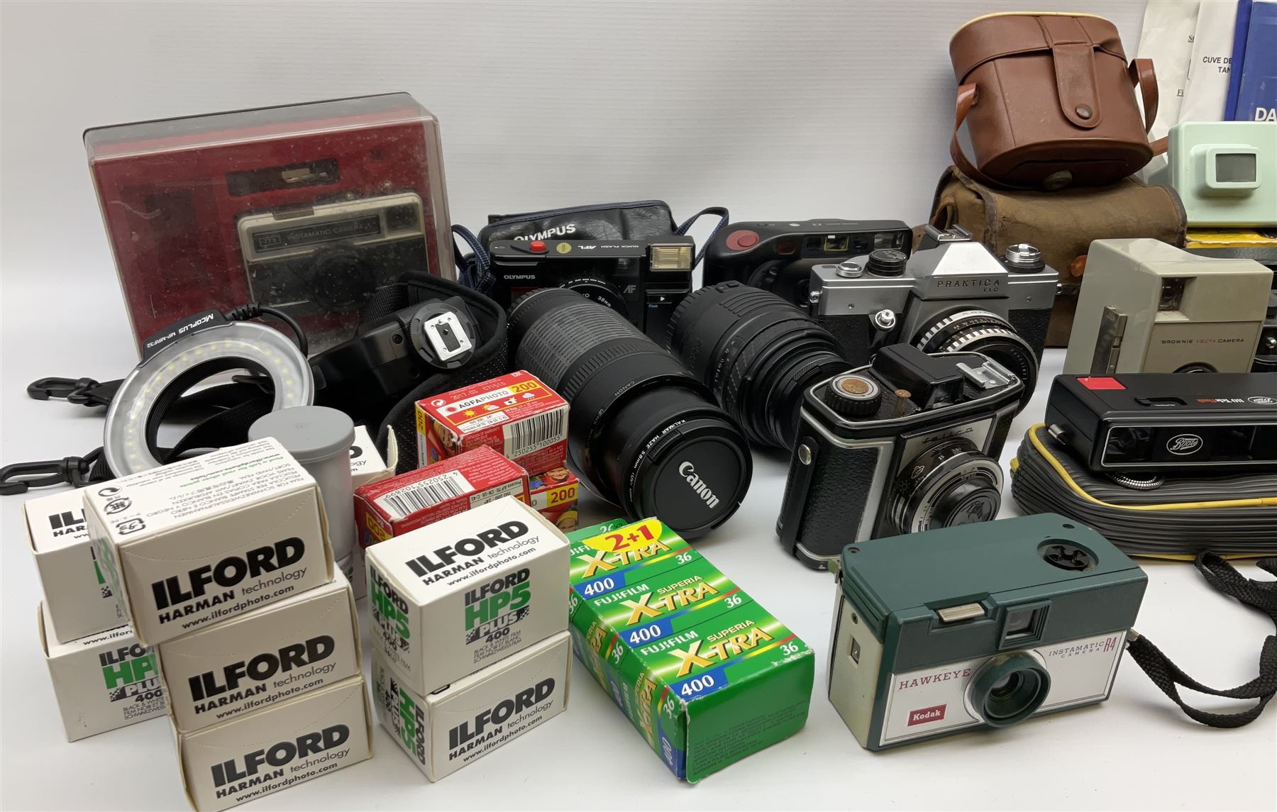 Vintage and later cameras, lenses, accessories and darkroom equipment including Zenit 12XP camera, Praktica BX20 camera fitted with 'Sigma Zoom Master 1:3.5-4.5 f=35-70mm' lens, Praktica LLC camera fitted with 'Carl Zeiss Jena Pancolar 1.8/50' lens, Canon Zoom Lens 'EF 100-300mm 1:5.6', various Jessop and other makers darkroom items including safelight (Red), universal duo tank, multi-mask enlarging easel etc, in three boxes