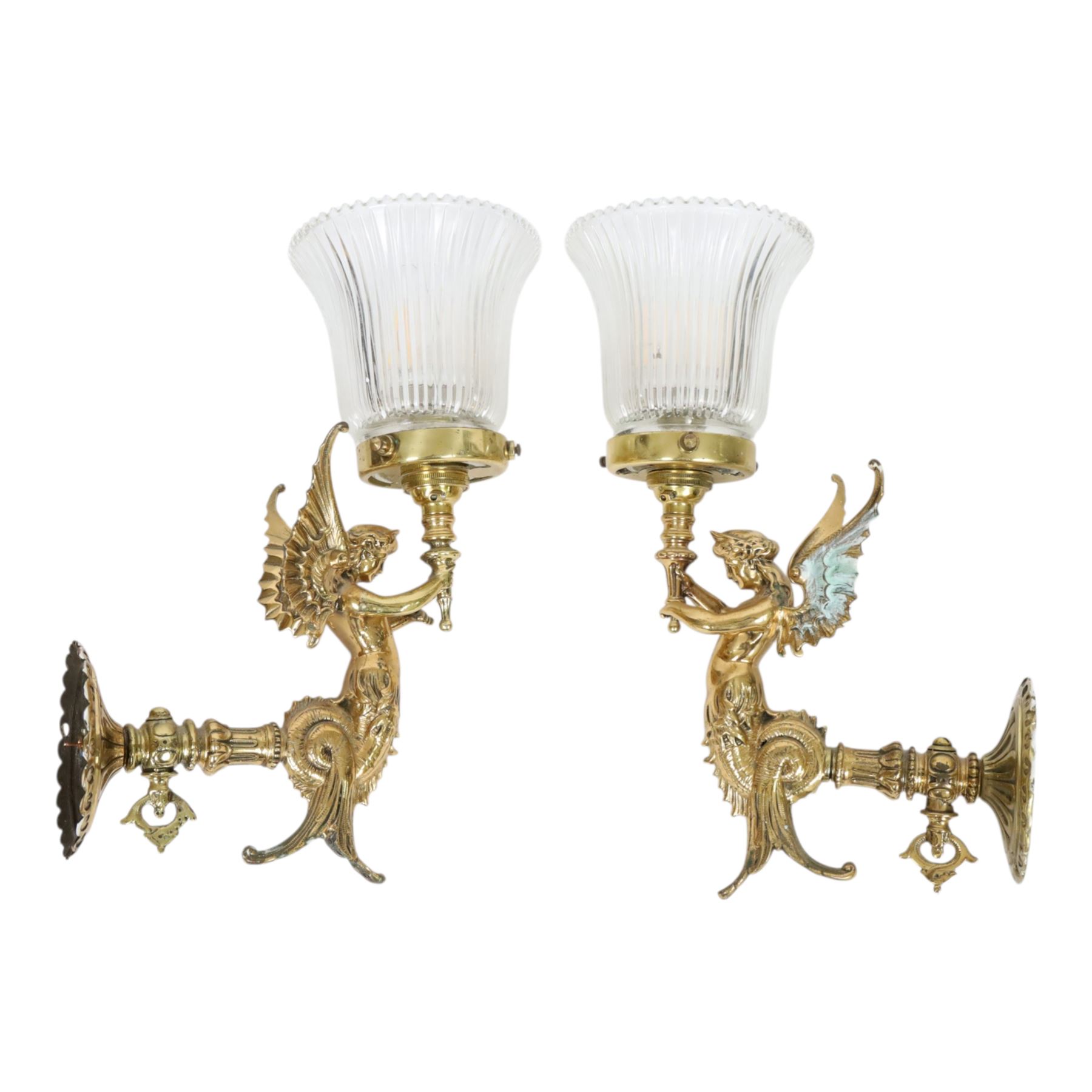 Pair of Victorian style wall sconces, each modelled as a caryatid supporting a single light fitting in one raised arm, with tapering and fluted clear glass shade, approximately H31cm D21cm