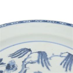 Two 18th century Chinese blue and white plates, comprising octagonal example with figural scene to centre and a larger circular example decorated with a garden scene, largest D27.5cm