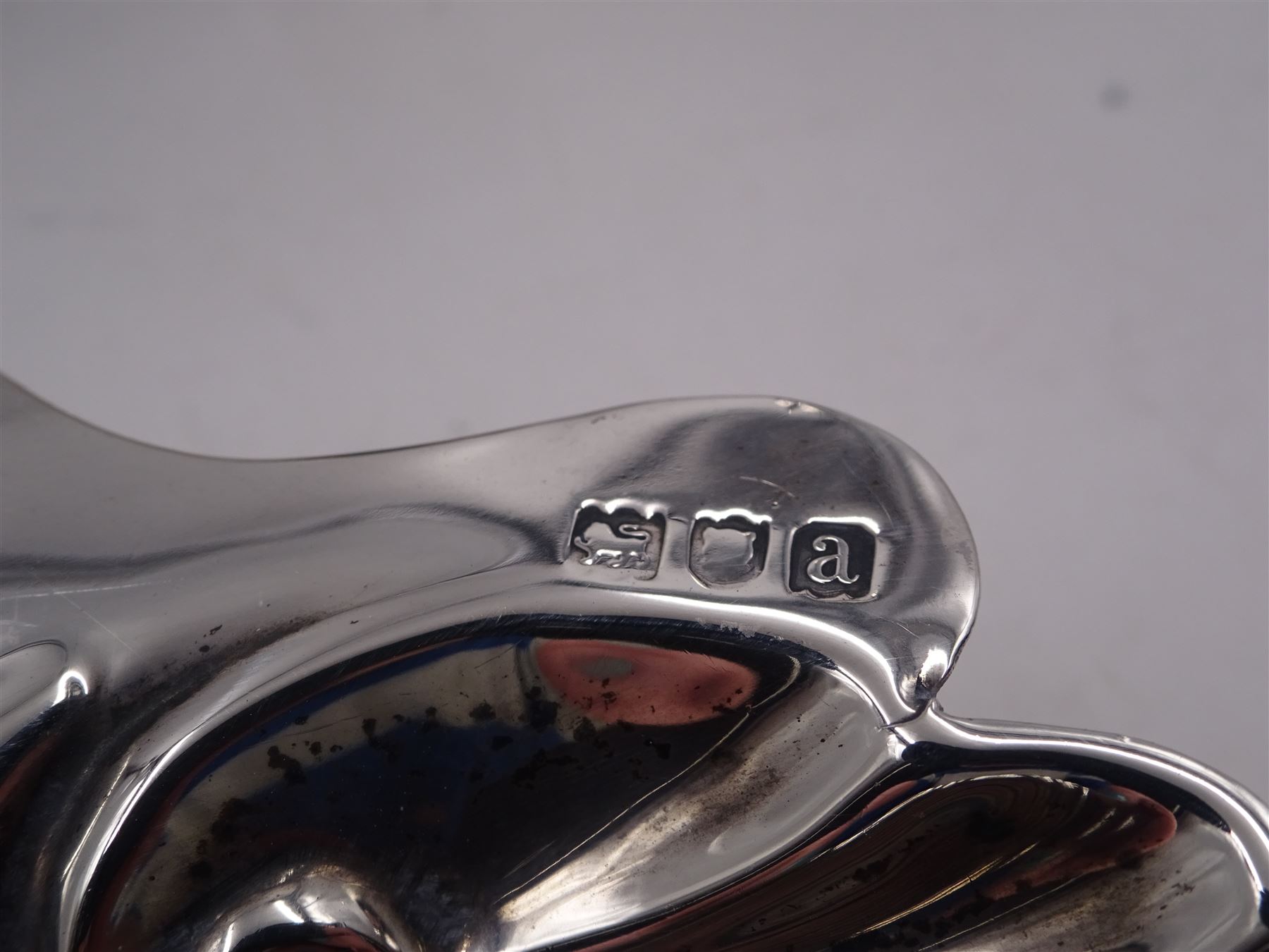 Victorian silver shell butter dish, upon three ball feet, hallmarked Josiah Williams & Co, London 1896, together with a 1920s silver egg cup, engraved 'Barbara', hallmarked Joseph Gloster Ltd, Birmingham 1929, a 1920s silver five bar toast rack, with loop handle, hallmarked William Greenwood & Sons, Birmingham 1928 and a mid 20th century silver milk jug, hallmarked James Dixon & Sons Ltd, Sheffield 1944, tallest H8.5cm