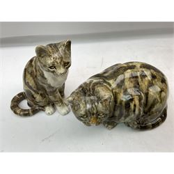 Pair of Winstanley cats, comprising larger example modelled as a crouching cat, size 5, together with smaller modelled seated, size 4, both with inset glass eyes, tallest H22cm, both with painted marks beneath