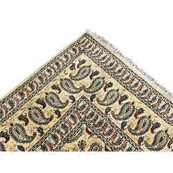 Persian ivory ground carpet, the field decorated with all-over Boteh motifs, the multi-band border with repeating Boteh patterns 
