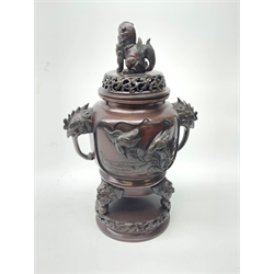 A 20th century Japanese bronze tripod censer, pierced cover with Dog of Fo Finial, the body cast in high relief with birds amongst branches, cockerel moulded handles above a pierced circular stand, H46cm 