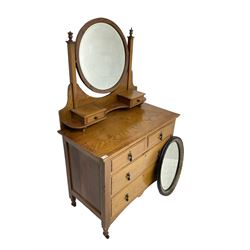 Early 20th century oak dressing chest, circular bevelled swing mirror over two small trinket drawers, fitted with two short and two long drawers, together with an oval wall mirror