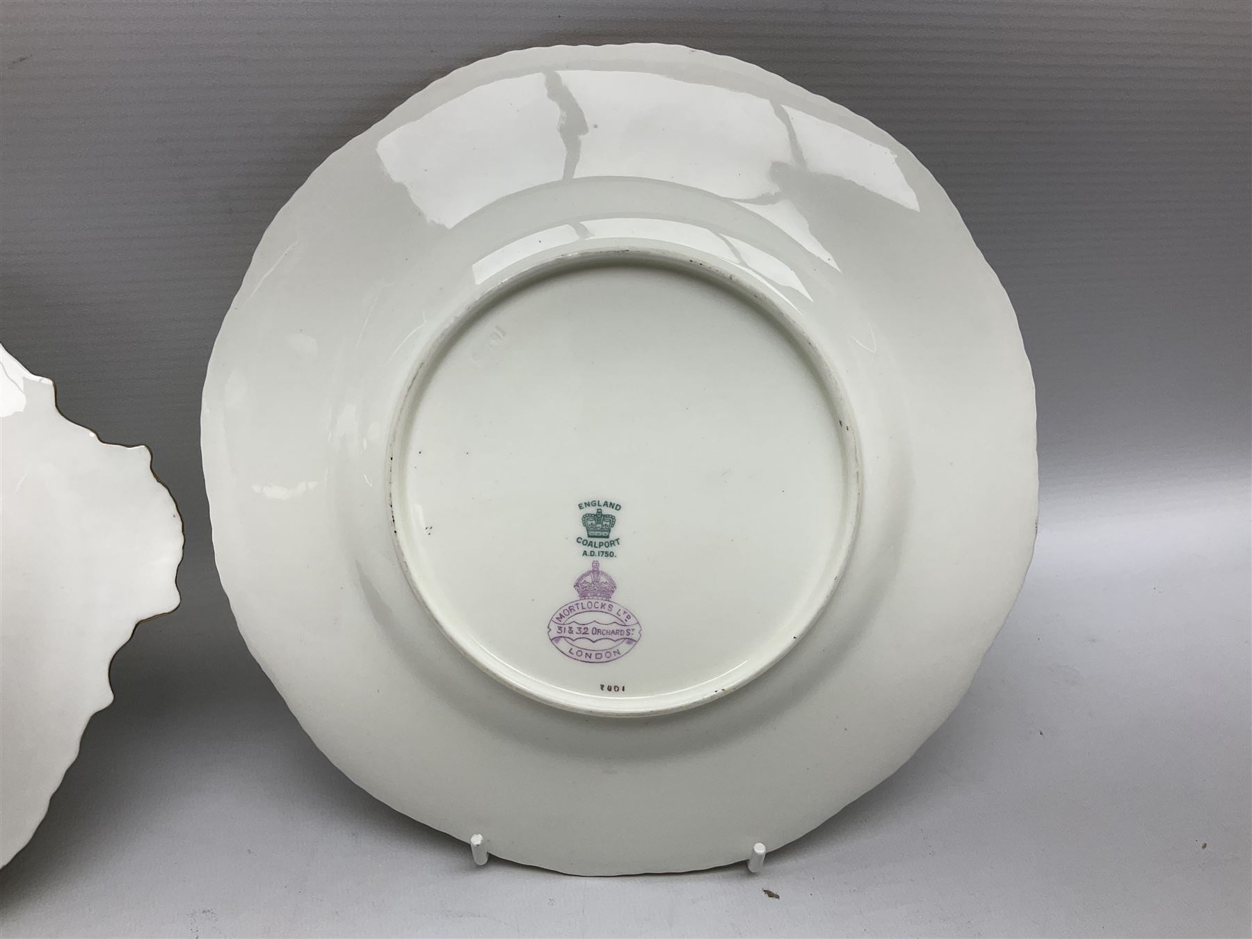 Coalport green batwing pattern tea wares, decorated with finely enamelled floral sprays within gilt reserves, comprising teacup trio, twin handled cake plate and side plate, pattern no Y2665, together with a Coalport for Harrods cup and saucer similarly decorated, the saucer with stamped mark beneath 'Manufactured for Harrods Ltd, Brompton Rd London', all with green Coalport AD 1750 marks beneath, largest W31cm (7)