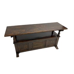 Jacobean design oak Monks bench, the front with carved linenfold panels, hinged metaphoric table back, hinged box seat compartment, on sledge feet