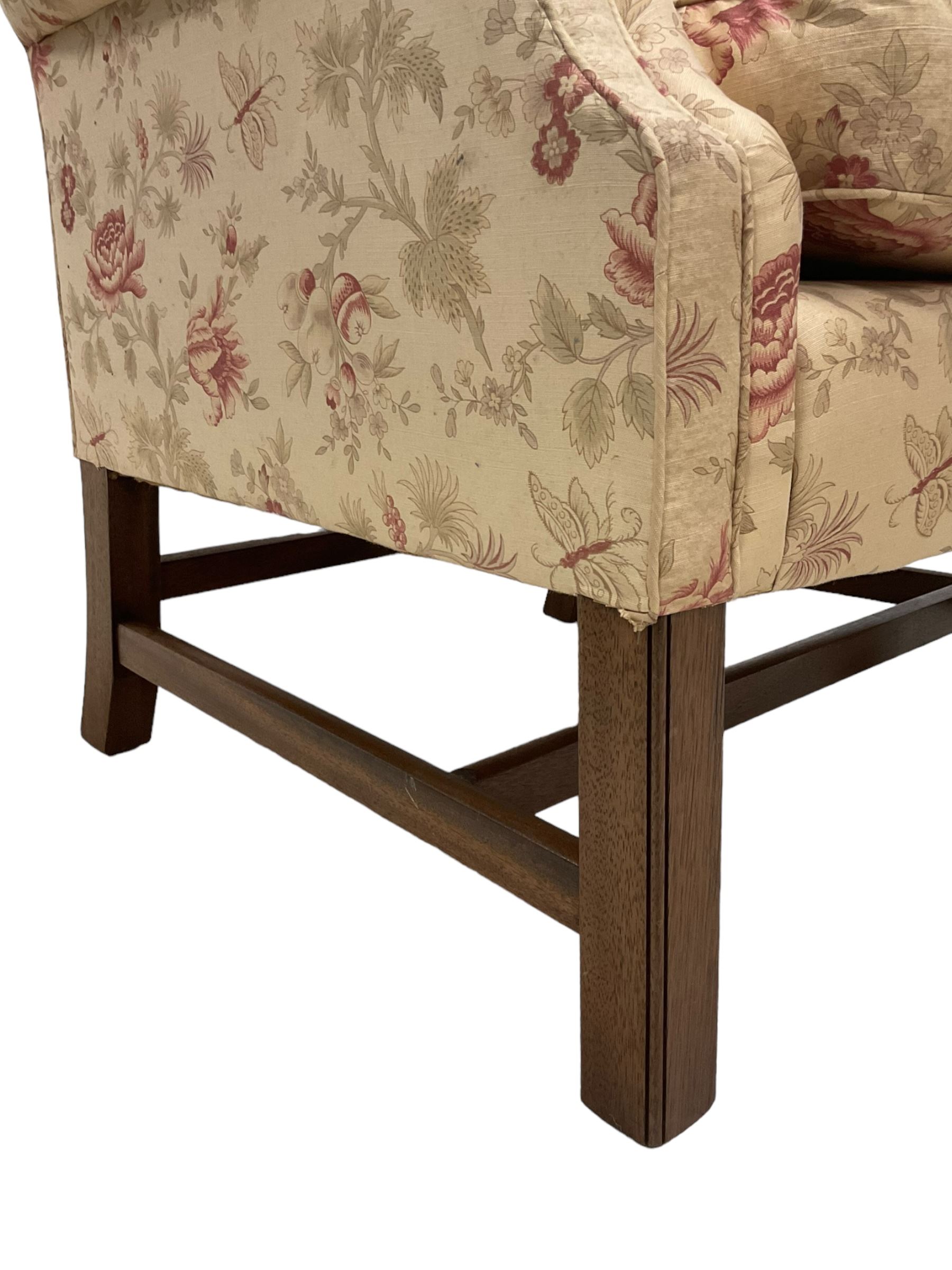 Peter Dudgeon - Georgian design mahogany framed armchair, shaped cresting rail over sprung back and seat flanked by rolled arms, upholstered in floral patterned fabric with matching seat cushion, on square supports joined by stretchers
Provenance: From the Estate of the late Dowager Lady St Oswald