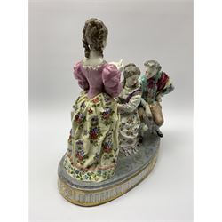 Large Continental figure group, in the Meissen style, modelled as three figures gathered around a piano, upon oval base with gilt detail to edge, with spurious blue crossed sword mark beneath, H30.5cm L32cm