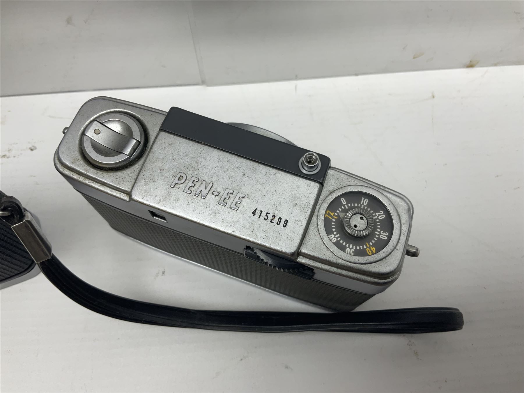 Olympus Pen-EE camera, serial no 415299, with Olympus D.Zuiko 1:3.5 f=2.8cm lens, together with four Olympus Trip 35 cameras, serial nos 4759245, 4257589, 1847727 and 5387611, each with Olympus D. Zuiko 1:28 f=40mm lenses