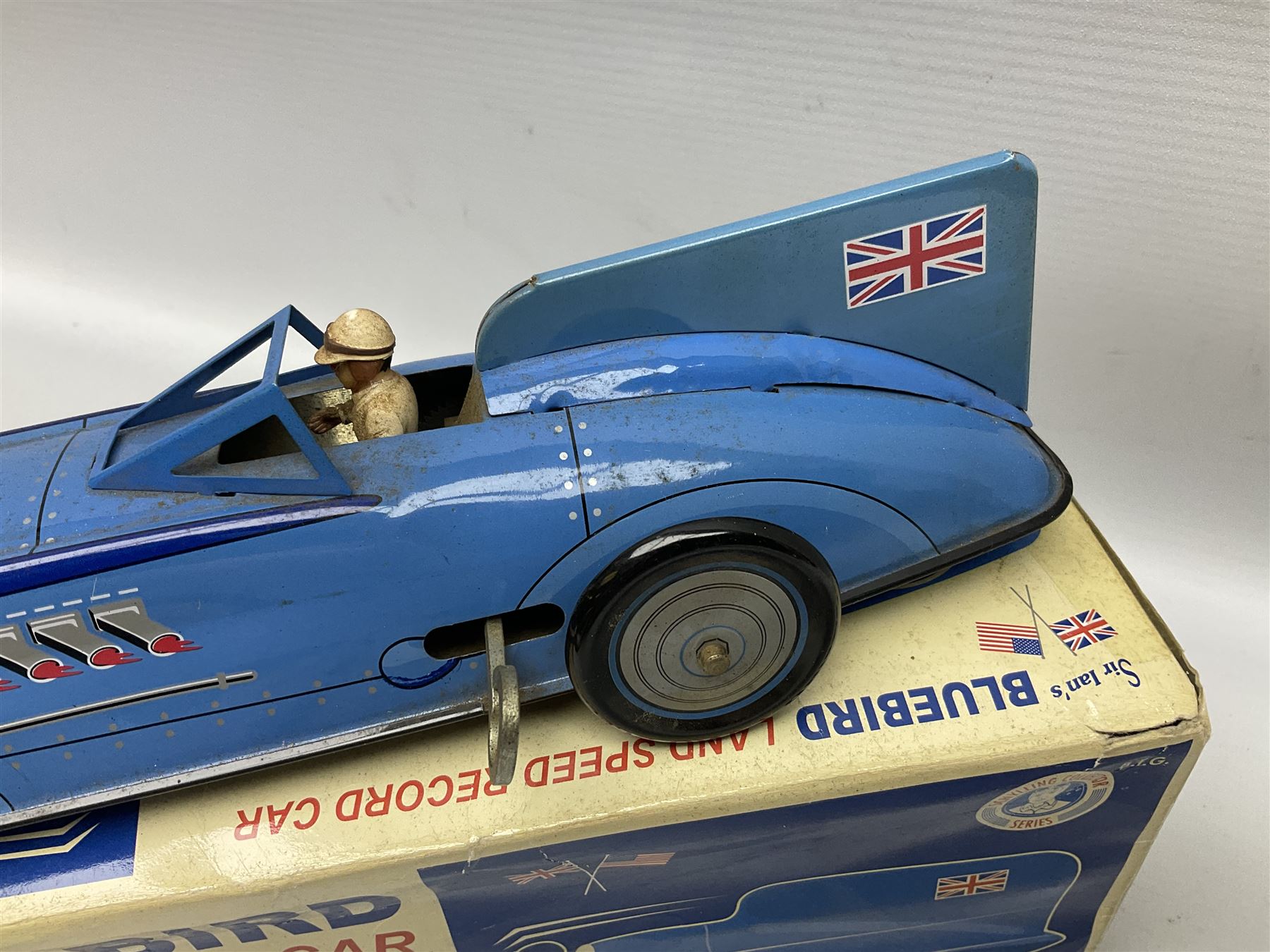 Schylling Collector Series clockwork tin-plate Sir Ian's Bluebird Land Speed Record Car with key and paperwork No.006080; boxed; and clockwork silvered tin-plate model of an 0-6-0 locomotive; unboxed (2)