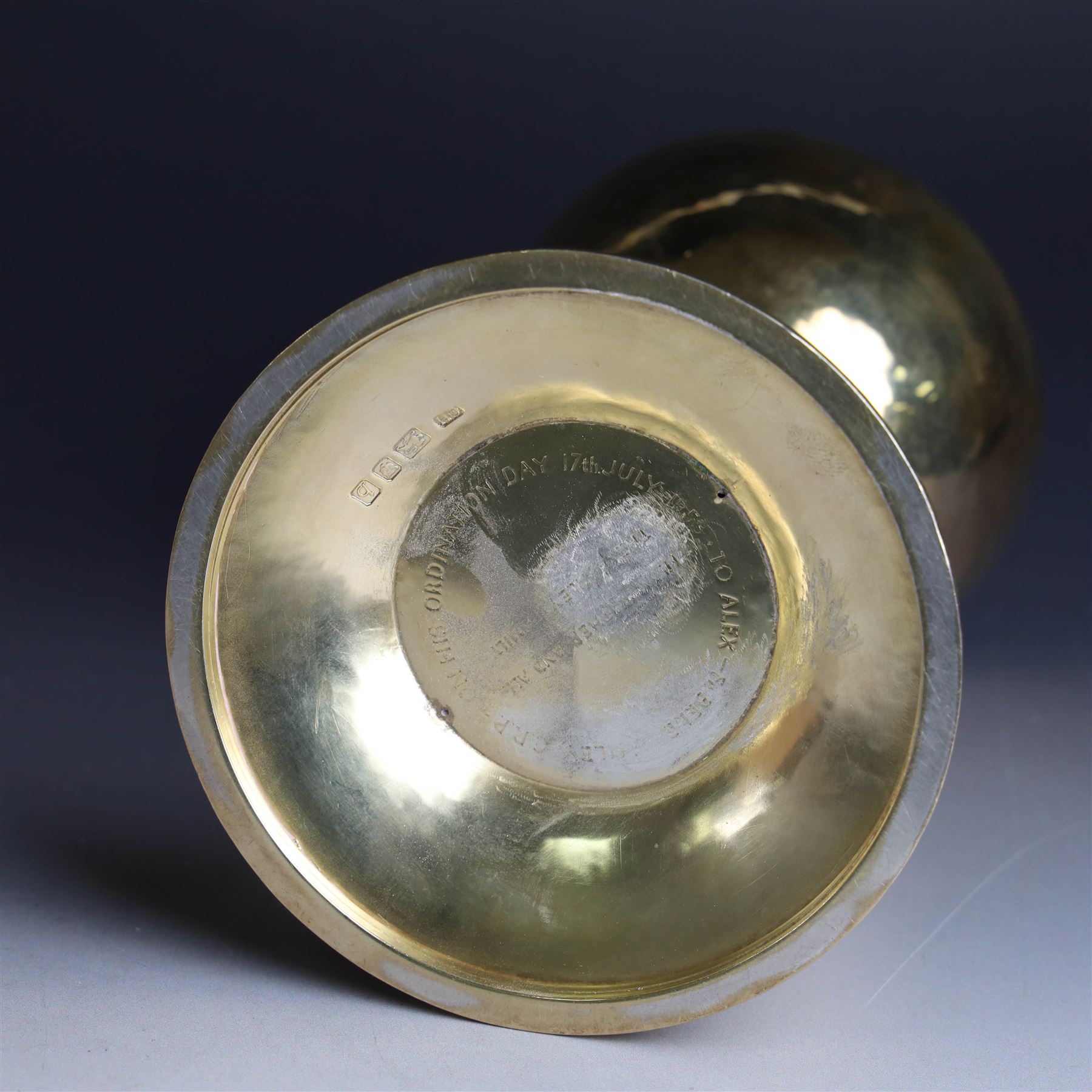 Mid 20th century silver-gilt chalice, the goblet with hammered finish upon knopped stem, the knop embossed with symbols and foliate decoration, engraved to base ' veni non ministrari sed ministrare' and with presentation engraving to underside, hallmarked Guild of Handicraft, London 1957, H17cm