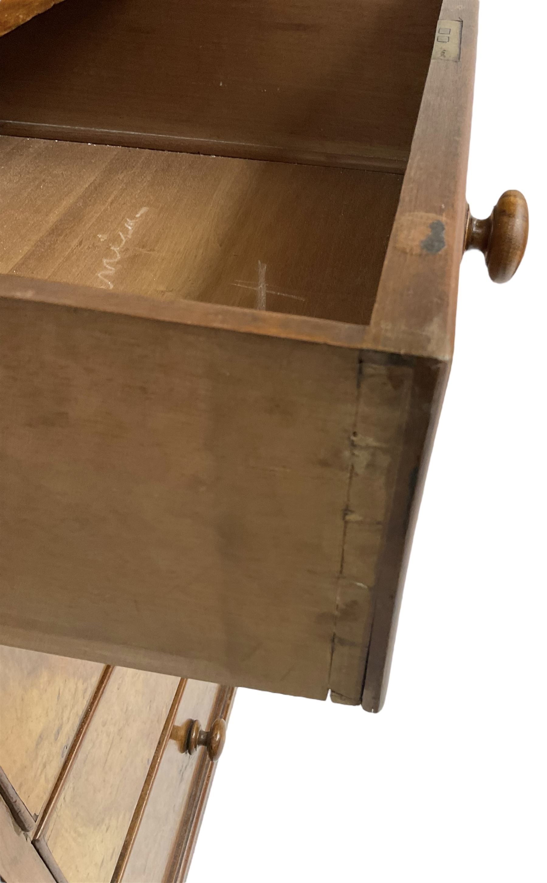 Early 20th century figured walnut chest, fitted with two short over three long drawers with bookmatch veneer facias, each with turned walnut handles, skirted base over compressed bun feet 