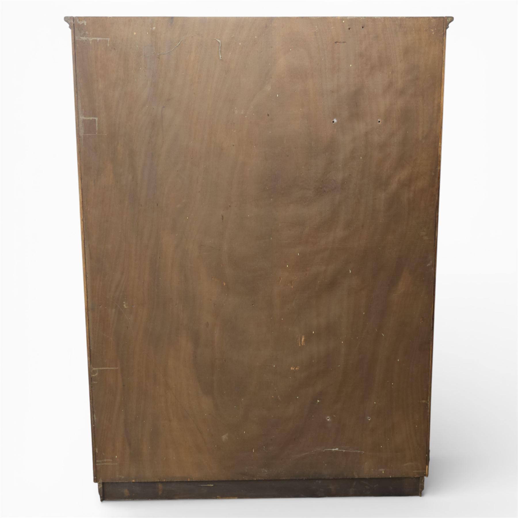 Edwardian oak glazed cabinet, moulded cornice above a panelled front and sides, fitted with lead glazed doors enclosing shelved interior, left side full length cupboard converted to enclose a gun cabinet, on a plain plinth base 