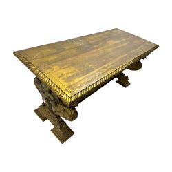 19th century Renaissance Revival carved and giltwood centre table, the rectangular top with gadrooned edge and carved frieze of repeating arched motifs with stylised scrolls, supported by a pair of carved winged griffin supports restrained by a central chained figure, on stepped rectangular bases united by carved stretcher