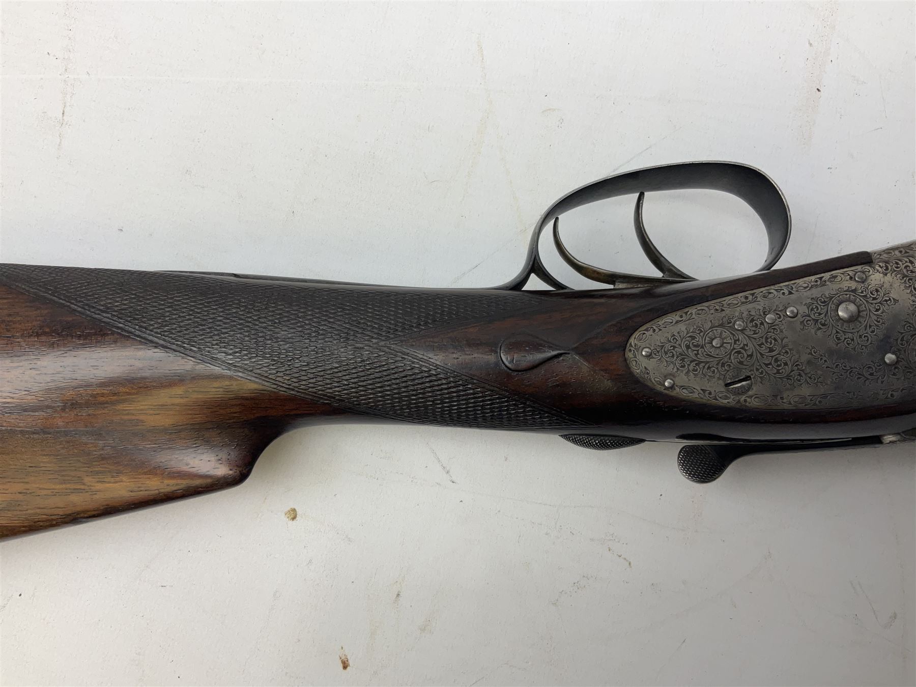 Smith Midgley Bradford 12-bore side-by-side double barrel side-lock ejector shotgun with 71cm barrels, engraved action with patented top lever, ivy leaf fences and top safety, walnut stock with chequered grip and fore-end, serial no.62409 to barrels and 1481 to action, L115cm overall SHOTGUN CERTIFICATE REQUIRED