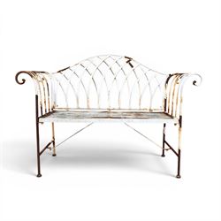 Small wrought metal two seat garden bench, finished in distressed white paint
