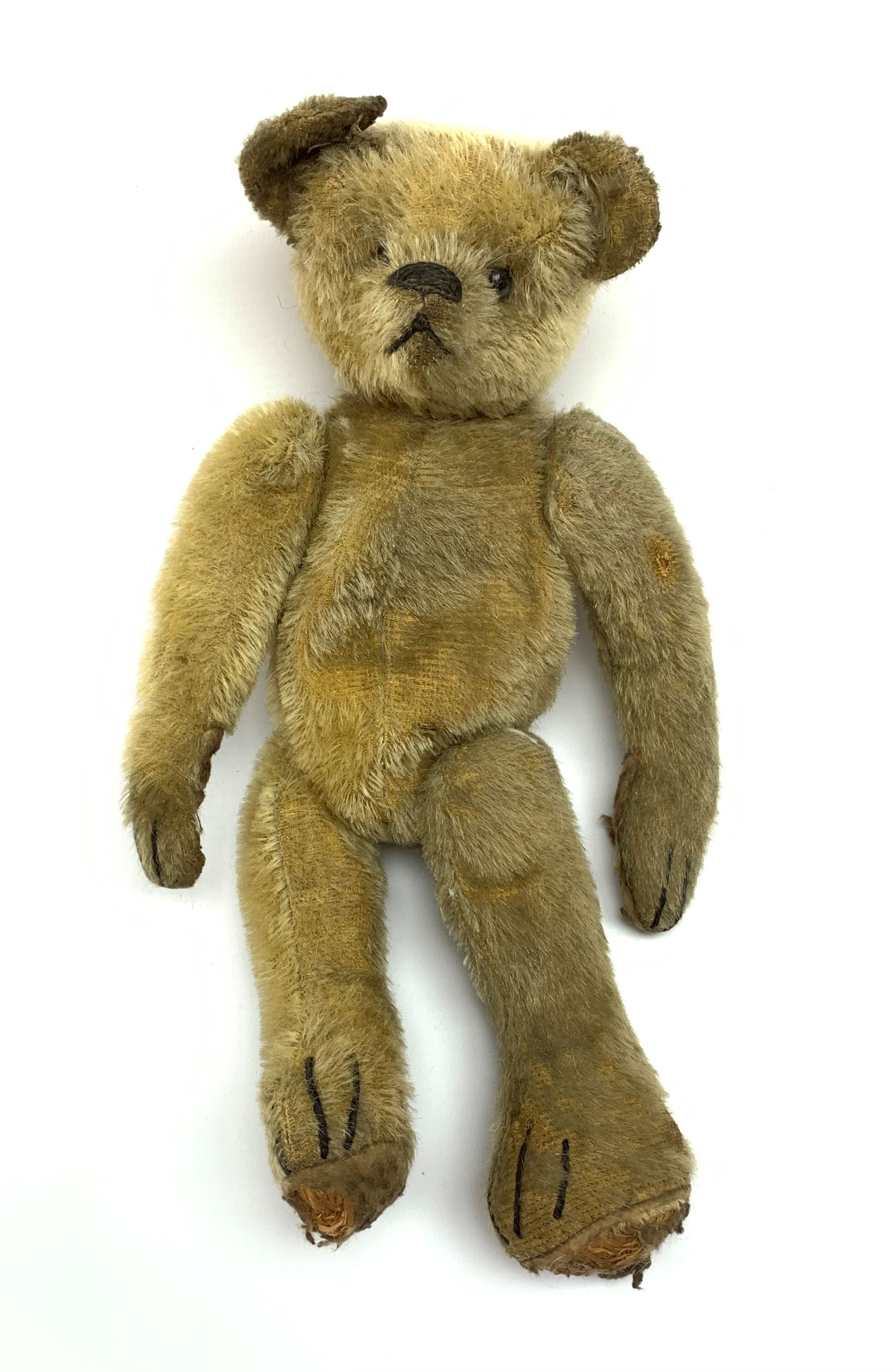 Early 20th century American mohair teddy bear c1920 with wood wool filled body humped back body with jointed limbs, black boot button eyes and horizontal stitched nose and mouth H12