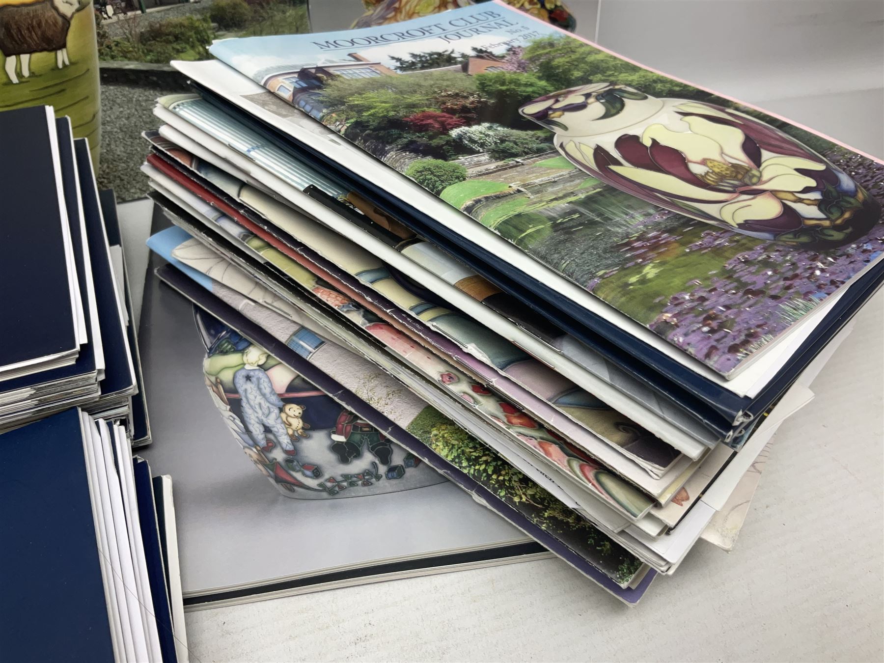Moorcroft, 1897-1993 revised edition; an illustrated guide to Moorcroft Pottery, a hard back book by Paul Atterbury, together with a quantity of Moorcroft Collector's Club magazines