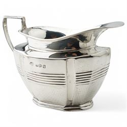 Late Victorian silver three piece tea set of panel sided oval design, the teapot with ebonised handle and lift, Chester 1898/99 Maker Florence Warden and William Aitken