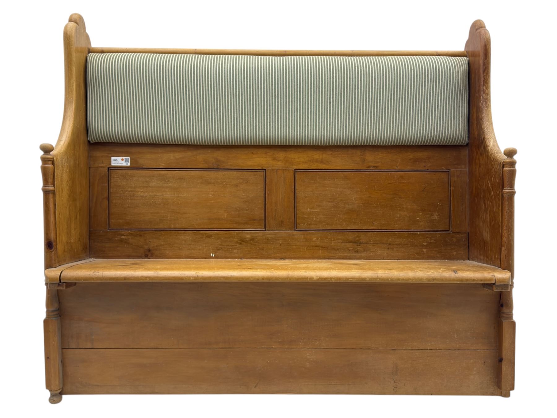 Early 20th century waxed pine pew, inset upholstered striped back panel with hinged box seat enclosing storage, shaped arms and turned supports