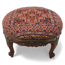 Two upholstered and caned footstools, a late Victorian carved mahogany footstool, oval form upholstered in geometric kilim-style fabric, on cabriole supports (H 27cm, W 56cm, D 47cm), together with a 20th century beech stool, square caned seat on turned supports united by stretchers (H 43cm, W 44cm, D 37cm)