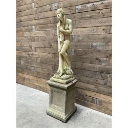 Cast stone garden figure of a bathing lady, raised on square plinth