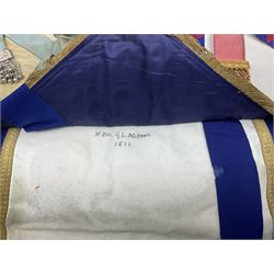 Two Masonic kid leather aprons, one with sash and cuffs, the other with sash, each marked 'Yorkshire North and East Ridings'; and three other unmarked Masonic aprons with sashes