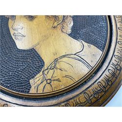 Aesthetic movement satin walnut turned pokerwork panel, of circular form depicting a head and shoulder portrait of a young figure, within a stylised border, D31cm