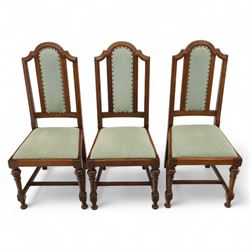 Victorian mahogany extending dining table, rectangular top with chamfered corners above a plain frieze raised on turned reeded legs with castors and two additional leaves, 197cm fully extended, and a set of six early 20th century oak upholstered chairs with drop-in seats, arched panelled back splat and close studded border on turned front legs joined by stretchers, 47x41x109cm 