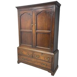 George III oak livery cupboard, projecting moulded cornice over two panelled doors, the upper panels within stepped ogee and arched moulded frame, the interior fitted with a single row of wooden hooks, two short and one long drawers, on bracket and return skirted base 