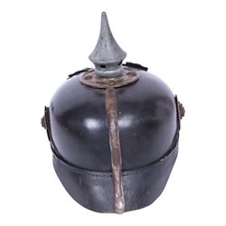 WWI Prussian M1915 Pickelhaube, the black leather skull with removable steel spike finial, steel eagle helmet plate and leather chin strap, one side with a black cockade, the other black and red