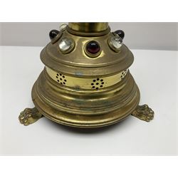 Brass alter cross, decorated with glass cabochons, upon a acicular stepped base and three claw feet, H73cm 