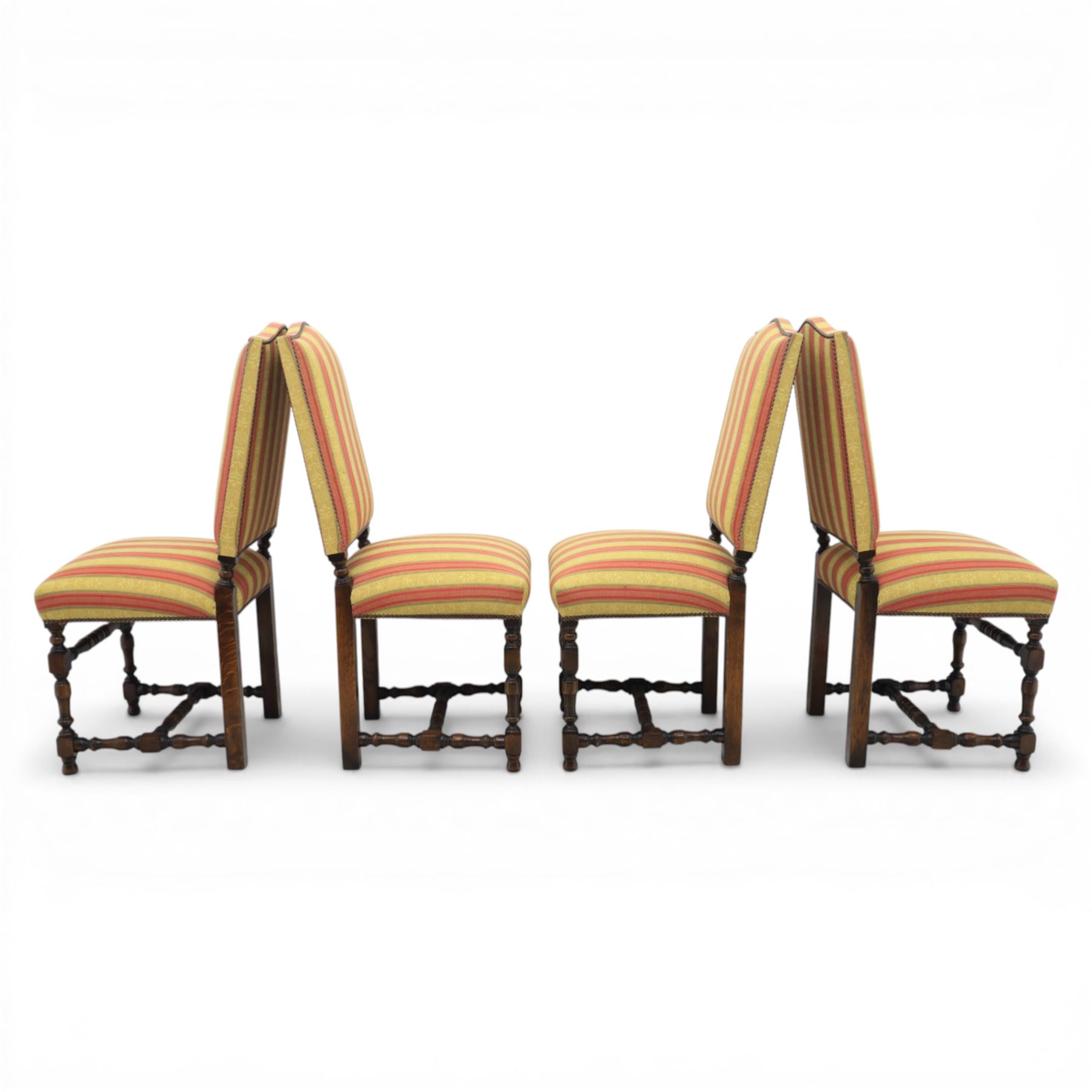 Royal Oak Furniture Co - Jacobean style oak dining table with suite of ten oak high back dining chairs (8+2), rectangular plank top dining table with moulded edge above carved frieze, raised on bulbous turned supports united by stretchers, together with a set of oak framed high back dining chairs including two carvers, upholstered in striped fabric with studded borders, on turned supports united by stretchers 