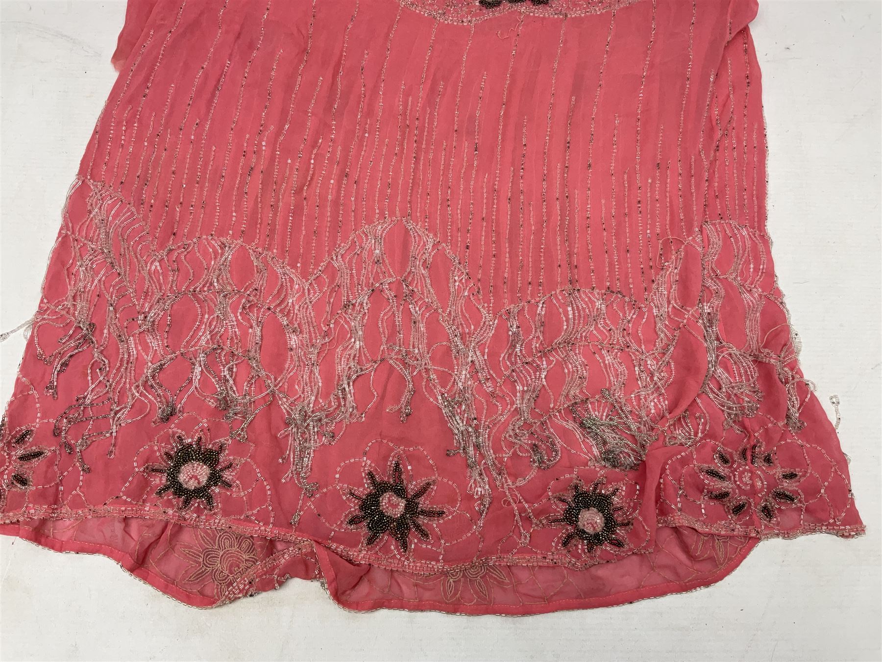 Art Deco pink flapper type beaded dress, with floral motifs and tasselled clear and black beadwork throughout