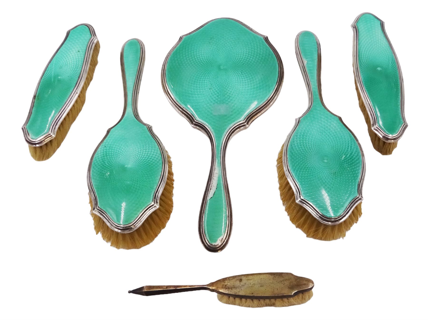 Art Deco five piece green guilloche enamel silver dressing table set, comprising hand mirror, two hair brushes and two clothes brushes hallmarked Barker Brothers Silver Ltd, Birmingham 1930, together with another silver brush, hallmarked Davis, Moss & Co, Birmingham 1928 (6)