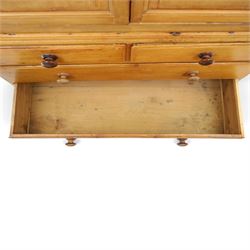 19th century waxed pine press cupboard, shaped cornice above a twin fielded panelled cupboard door enclosing a fixed shelf, the lower section two short two long drawer