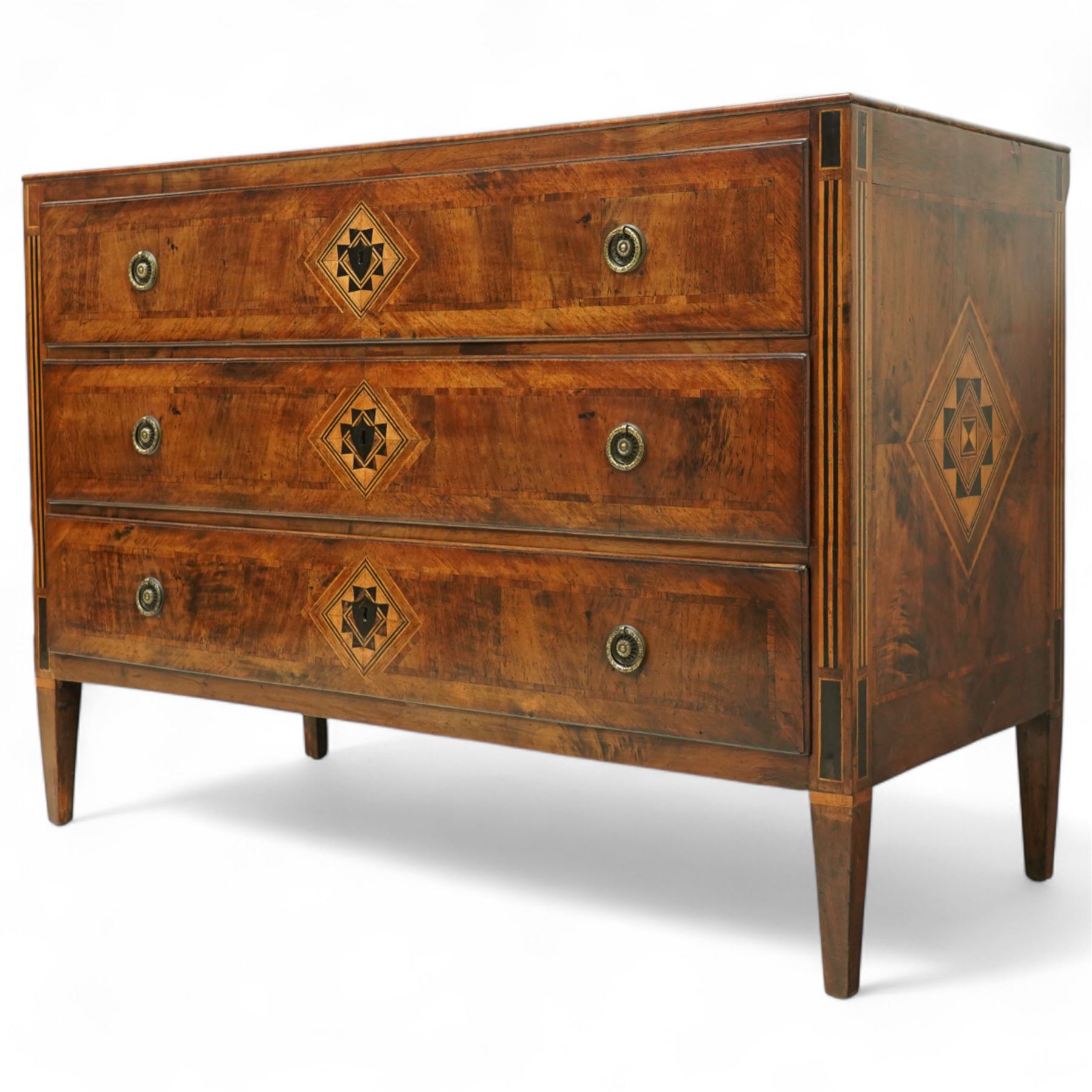 Large 18th-century North Italian walnut commode, rectangular top with quartered veneer, central parquetry inlay and raised moulded edges above three drawers with brass ring handles, cross banding and further central parquetry inlay, supported on square tapered feet