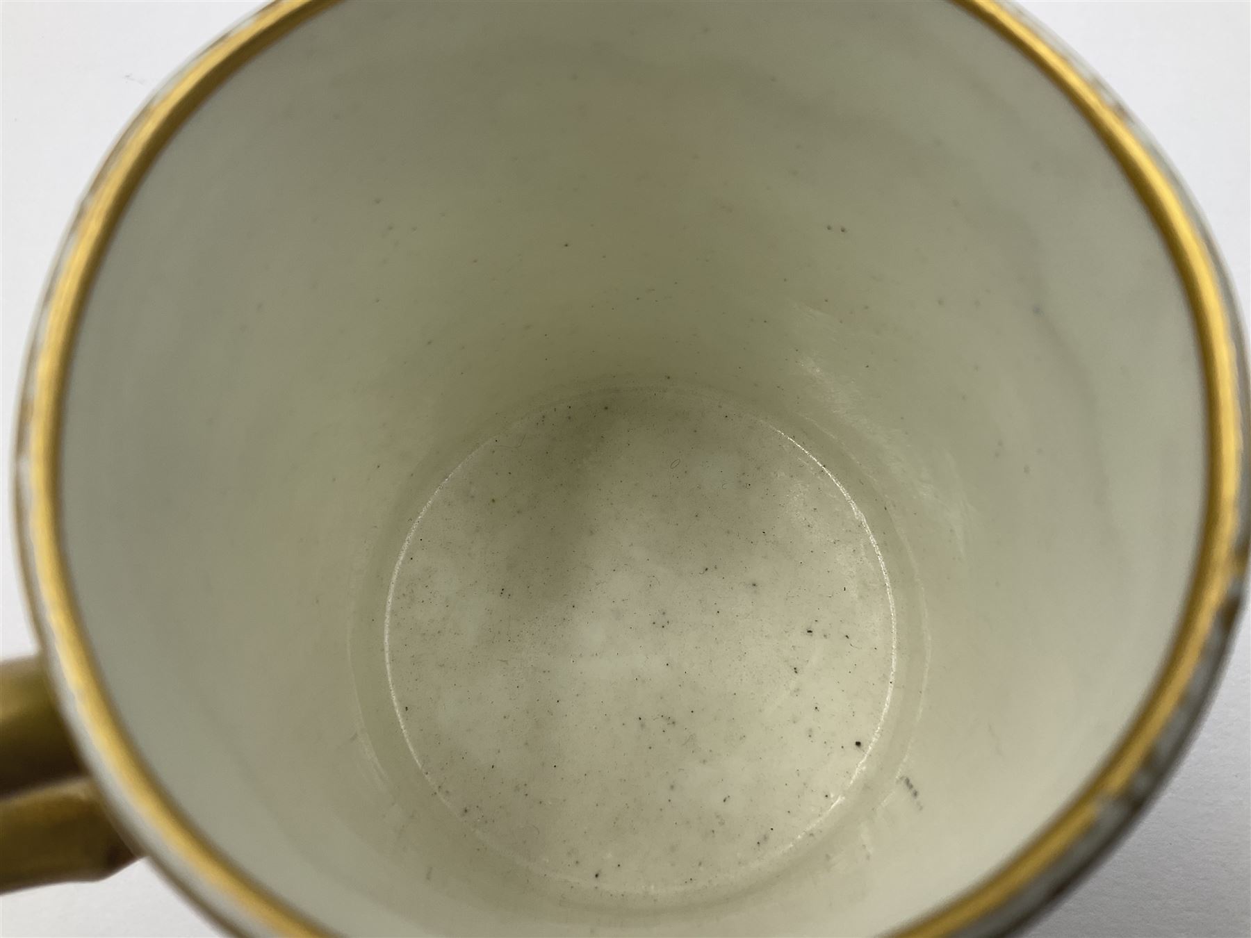 Sèvres soft paste porcelain coffee can and saucer with date code for 1754, painted and gilded with flowers, dangling from the shaped green border, interlaced LL monogram enclosing the date letter A above painters mark for Dodin, coffee can H7cm, saucer D14.5cm